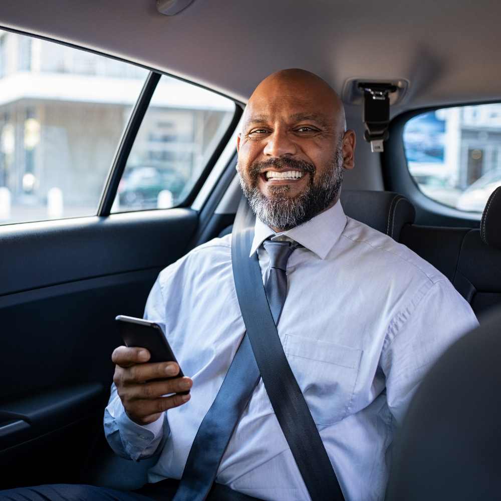 Rent a car nearby a man in a car holding a phone